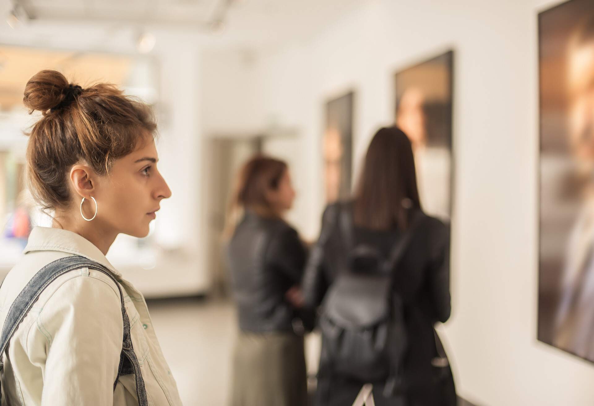 Group of woman looking at modern painting in art gallery. Abstract painting