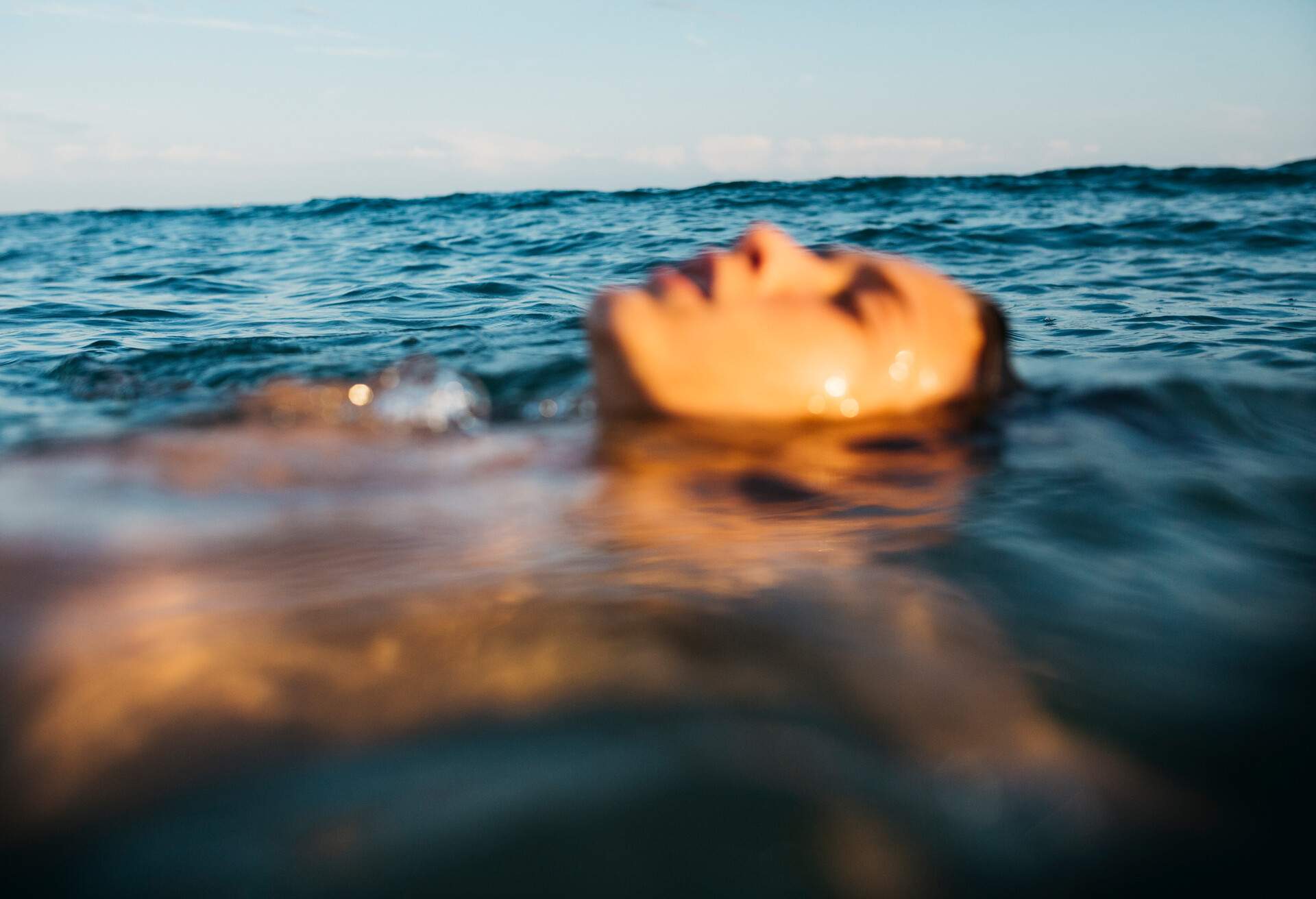 Twelve years old boy laying on the water's surface on the mediterranean sea