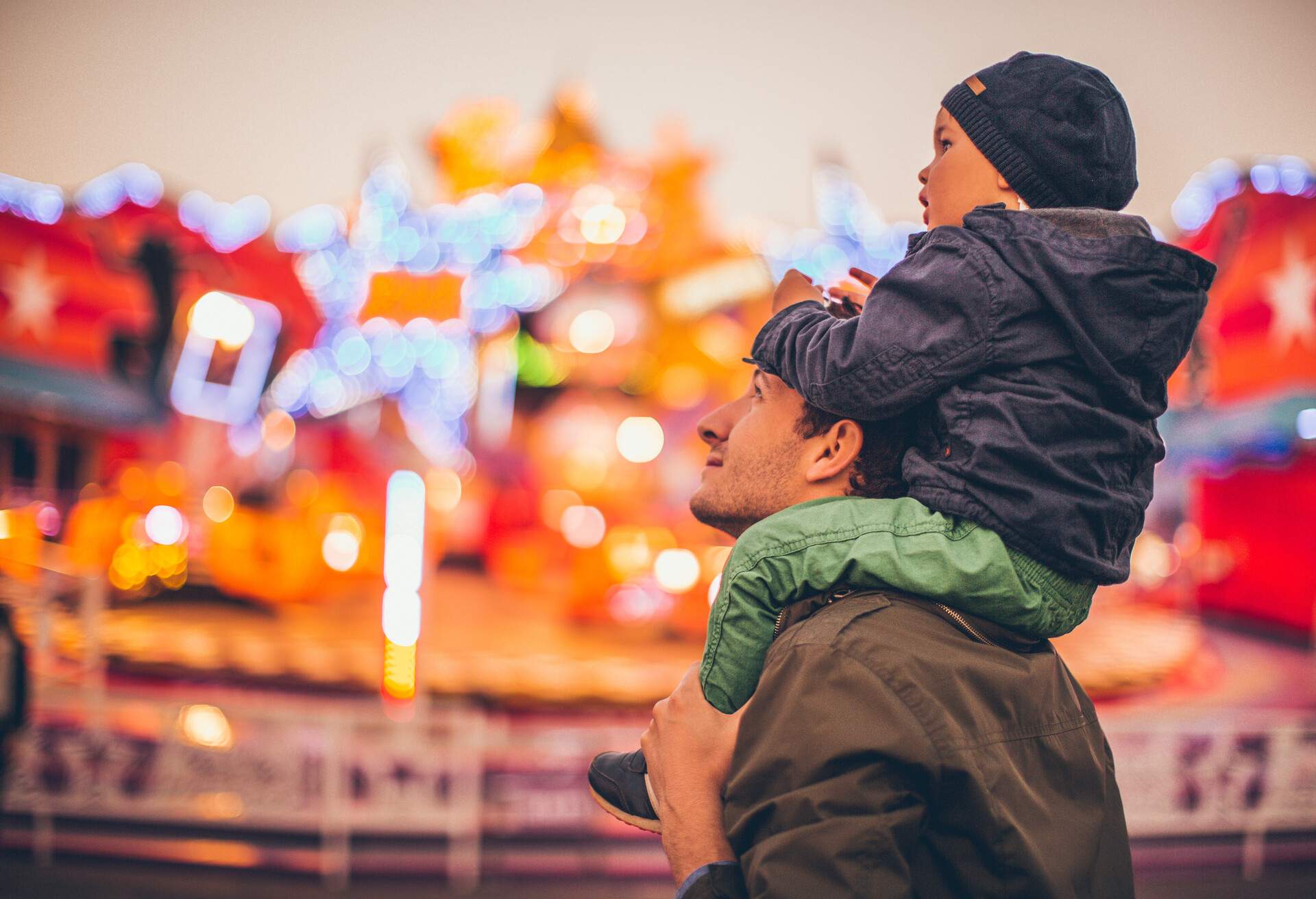 Father and son enjoy together in the amusement park.