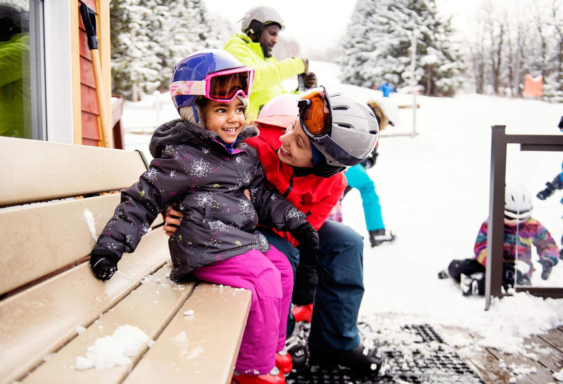 Black father with his multi daughter and son and his caucasian ethnicity wife skying during an afternoon day in a small town in Quebec Canada. It was their first time skying. They are with their caucasian friends. The color and horizontal photo was taken in Quebec Canada.