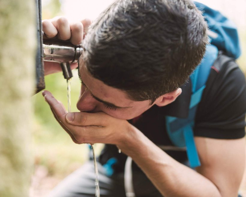 people_man_hike_water_drinking_well
