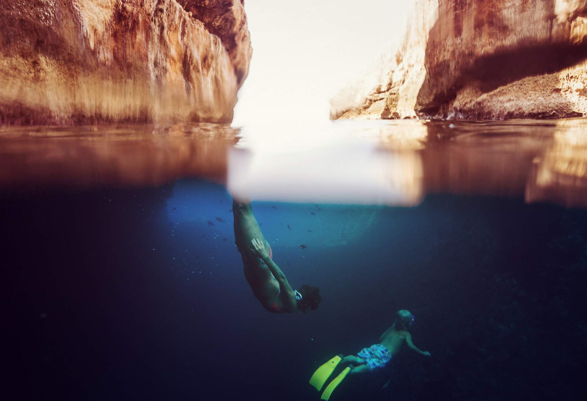 Two children swimming underwater with fins in Hvar Croatia