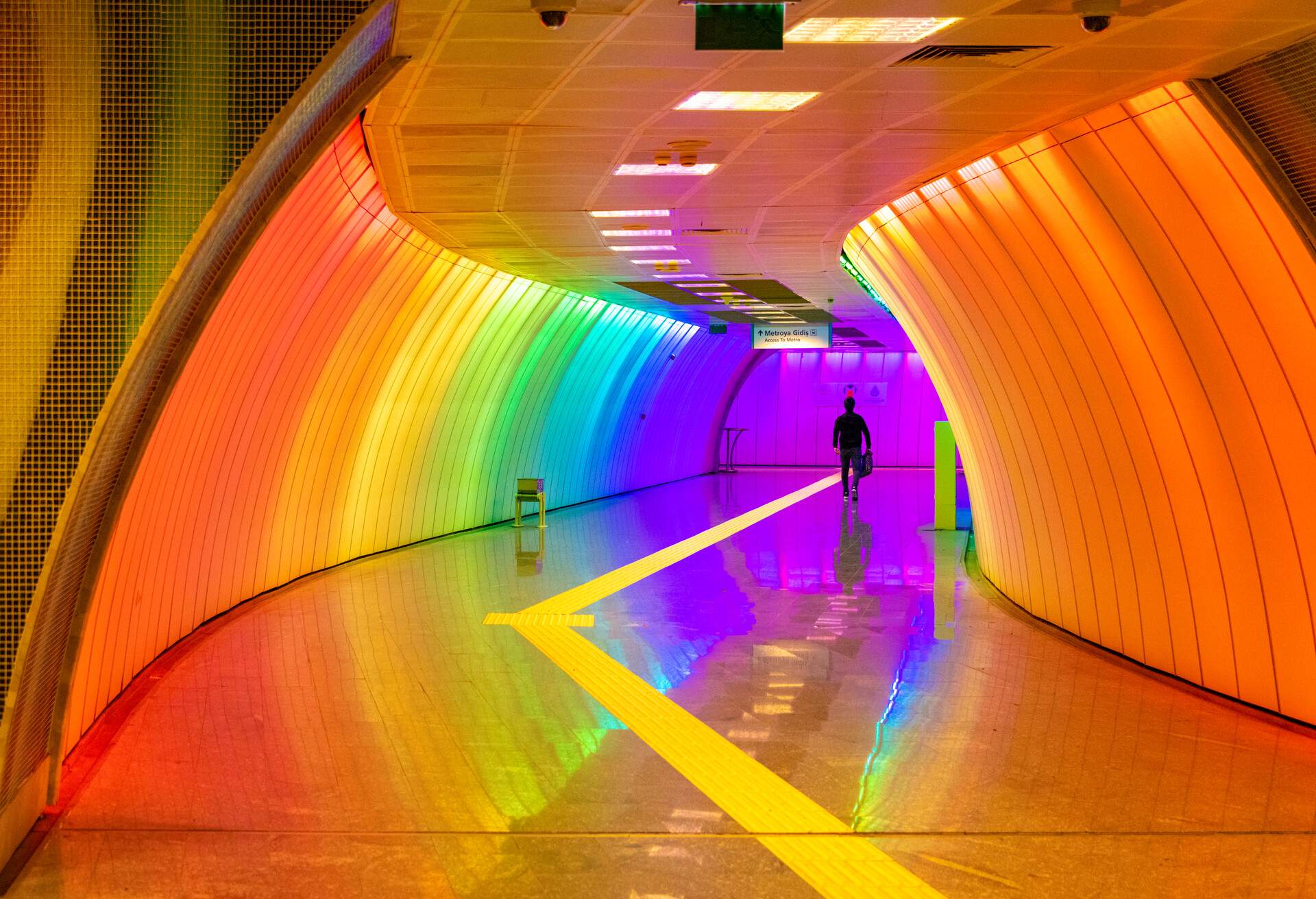 Commuters walking toward the underground in colorfully lit Levent station in Levent , Istanbul. 