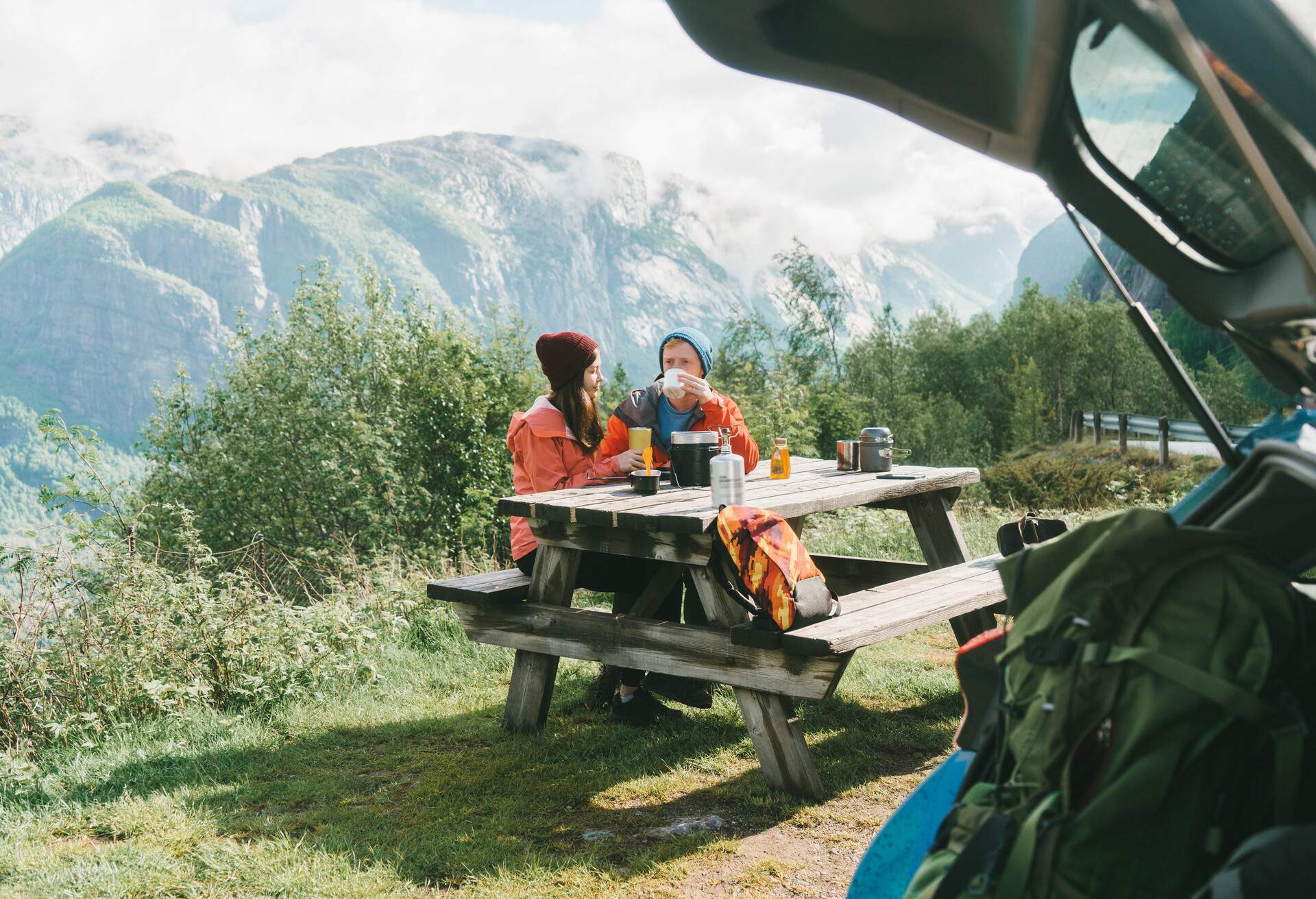 Young Caucasian couple have breakfast in mountains in Norway