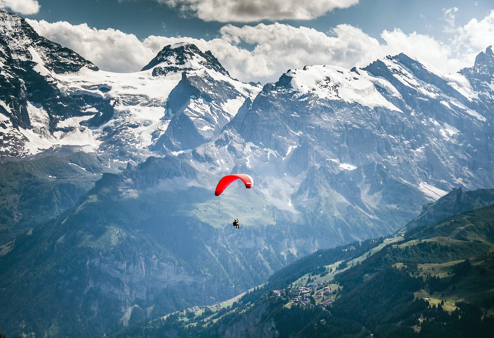 Paragliding over Swiss Alps at Männlichen in Wengen.