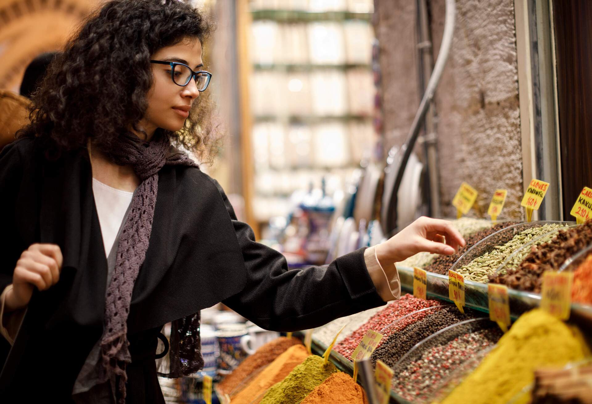 Woman shopping in spice shop in Grand Bazaar, Istanbul, Turkey