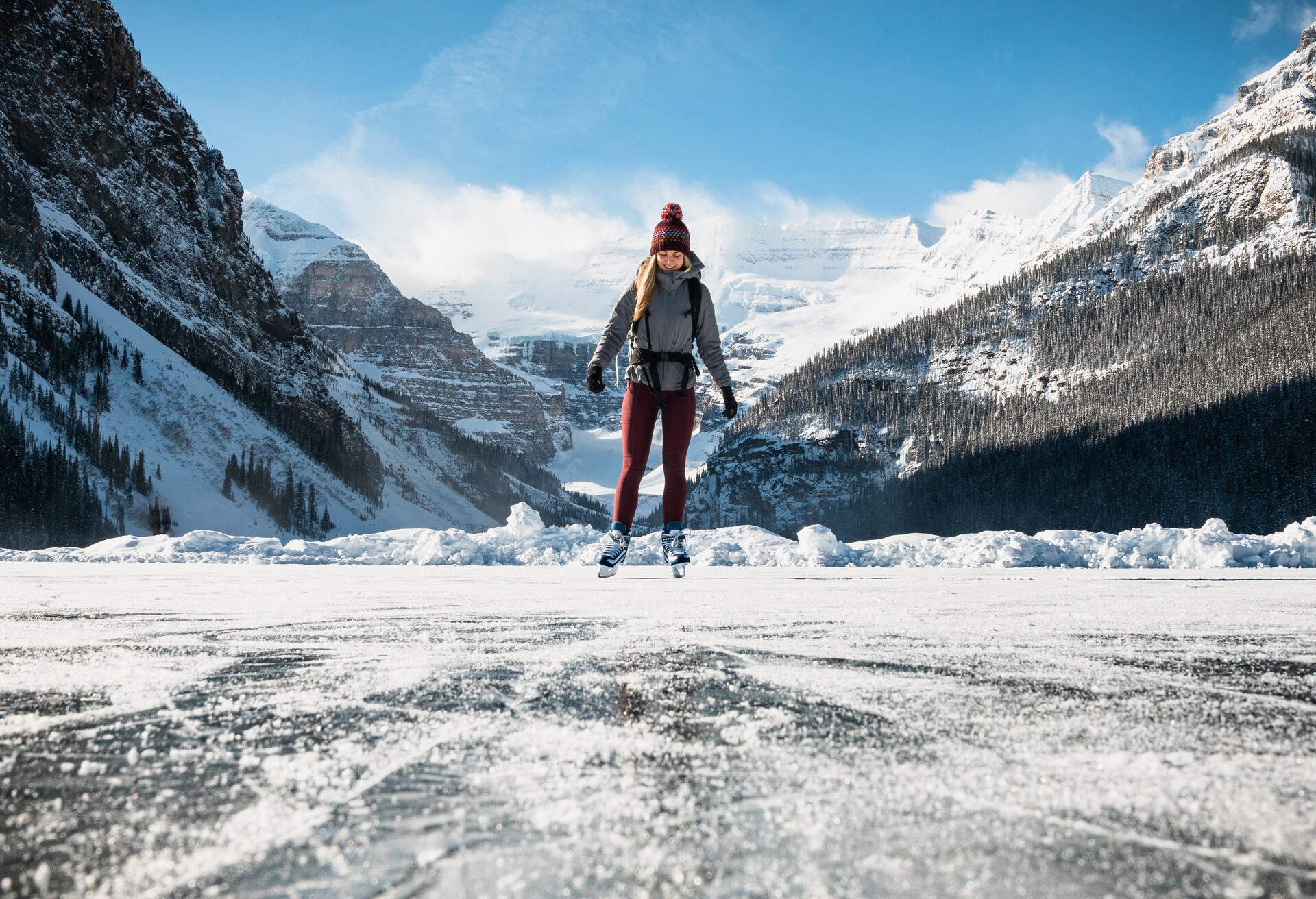 DEST_CANADA_FROZEN_LAKE_LOUISE_WOMAN_SKATING_GettyImages-1217400288