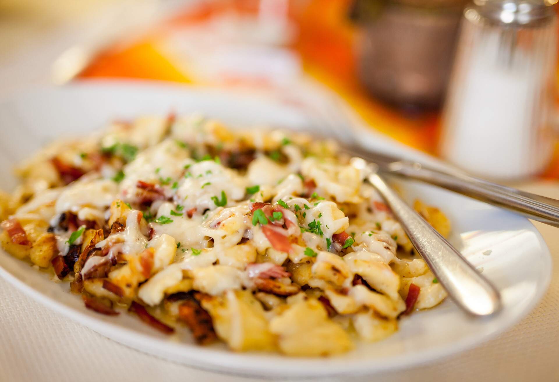 A typical Swiss dish that originated in the mountains. The key ingredients which are used are macaroni pasta, cheese, onions, and potatoes. 