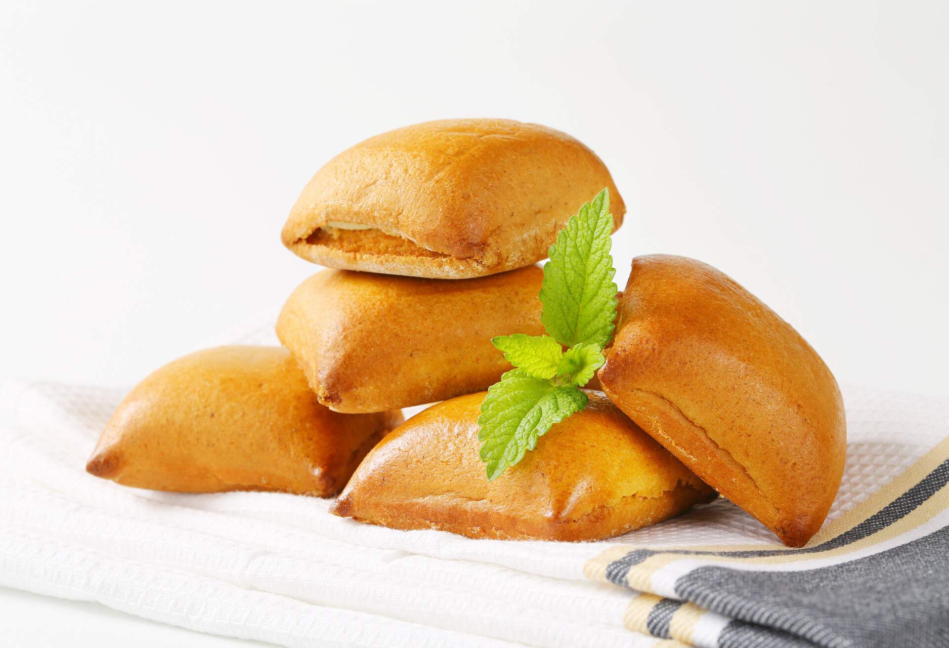 heap of biberli, swiss traditional gingerbreads with almond filling on folded dishtowel 