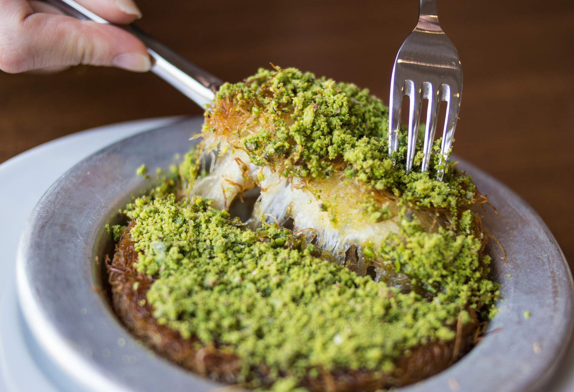 Kunefe / Turkish Traditional Dessert. Spelled kunafeh or kunafah is a cheese pastry soaked in sweet, sugar-based syrup, typical of the regions belonging to the former Ottoman Empire.