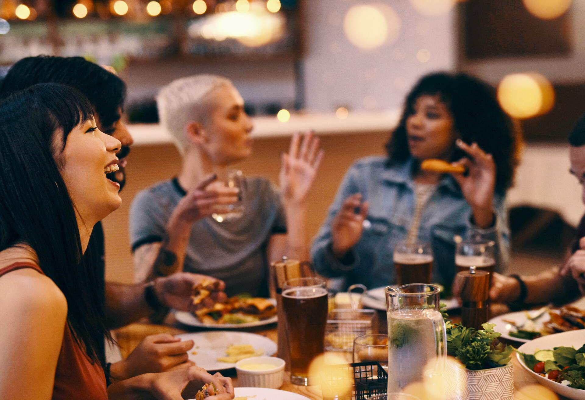 Cropped shot of friends enjoying a meal together at a restaurant