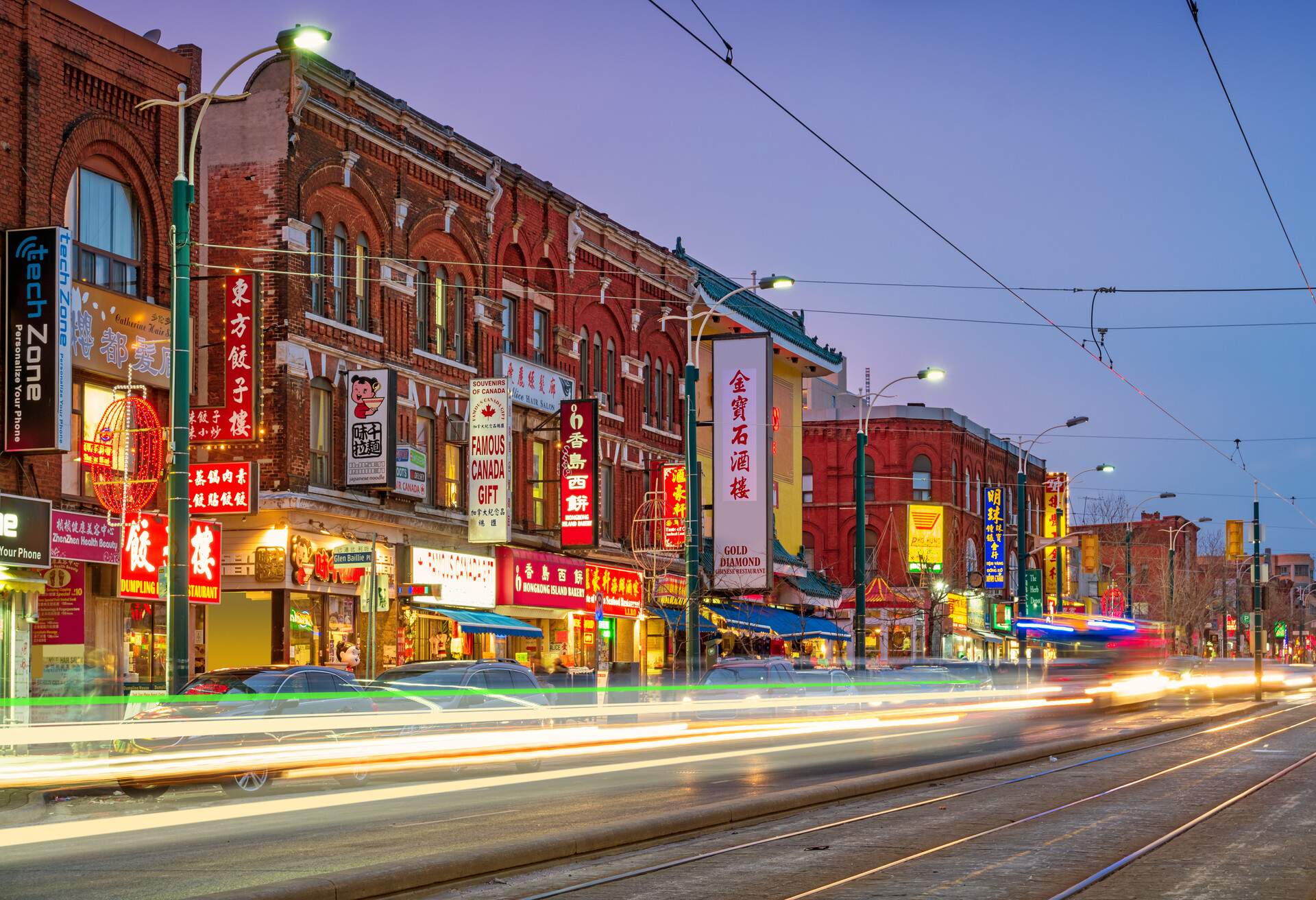 Long exposure stock photograph of Spadina Avenue in Chinatown, downtown Toronto, Ontario, Canada at twilight blue hour.