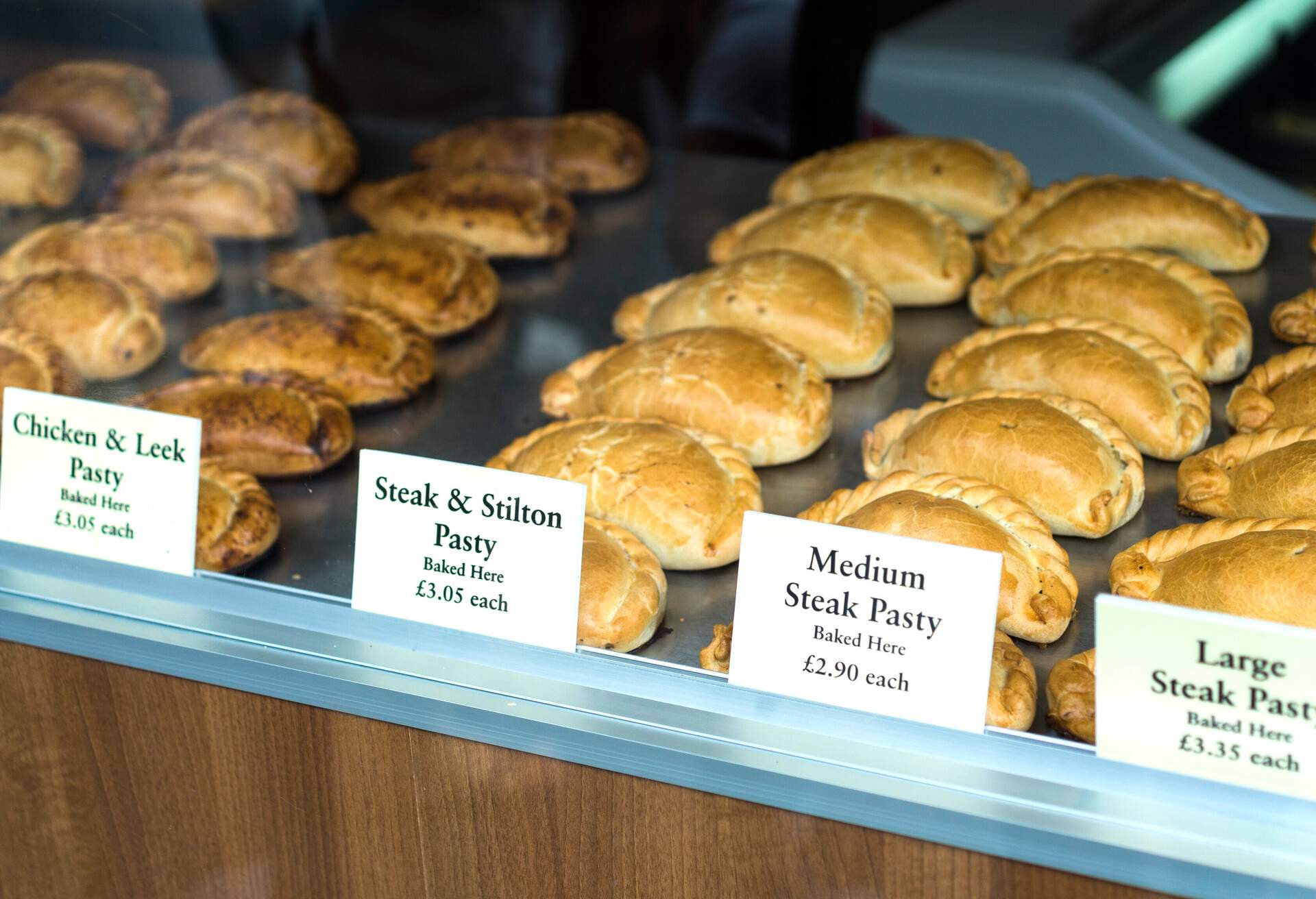 Different pasties being displayed in a windows shop in Cornwall. 