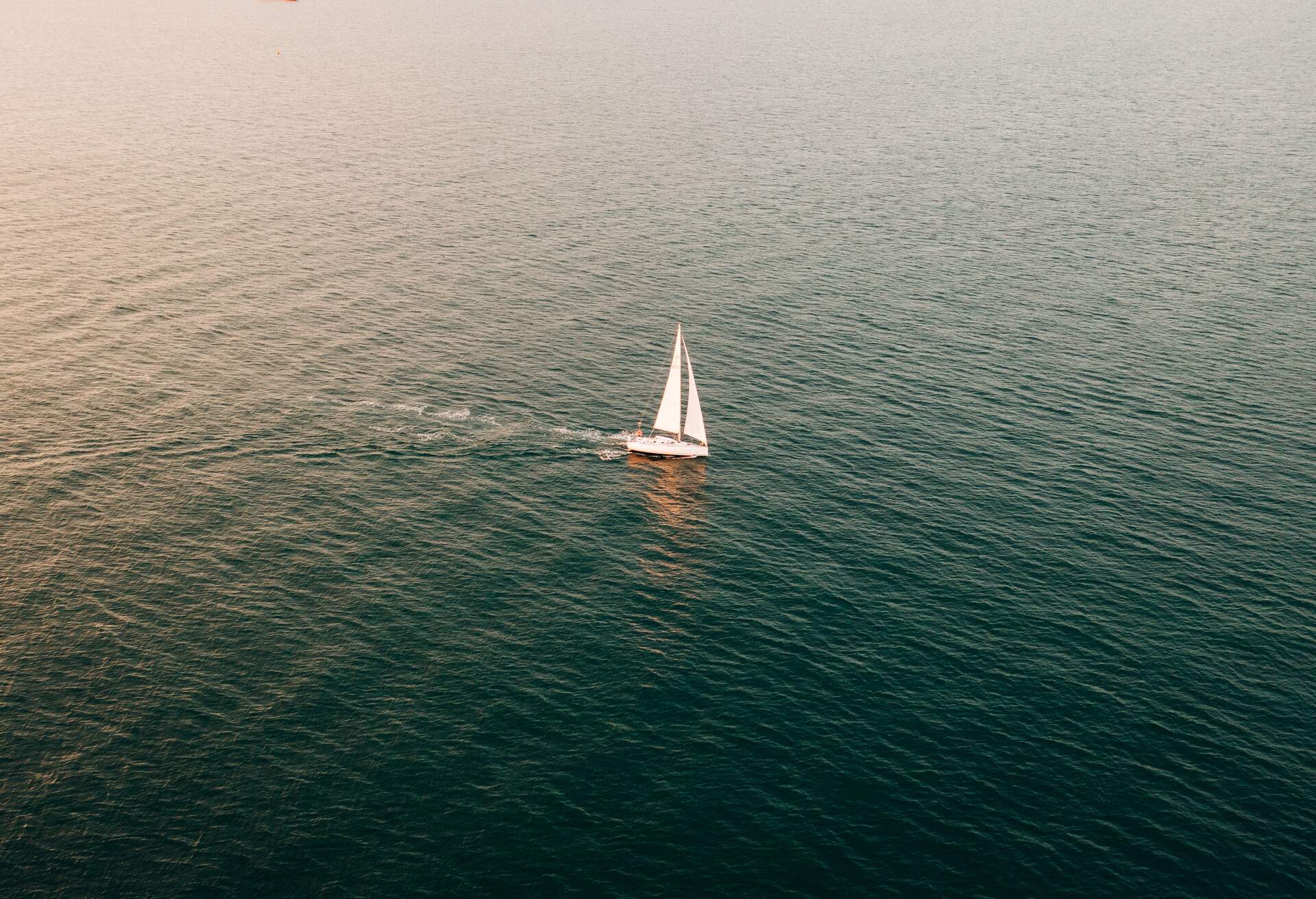 A yacht sailing on The Solent sea on a sunny evening