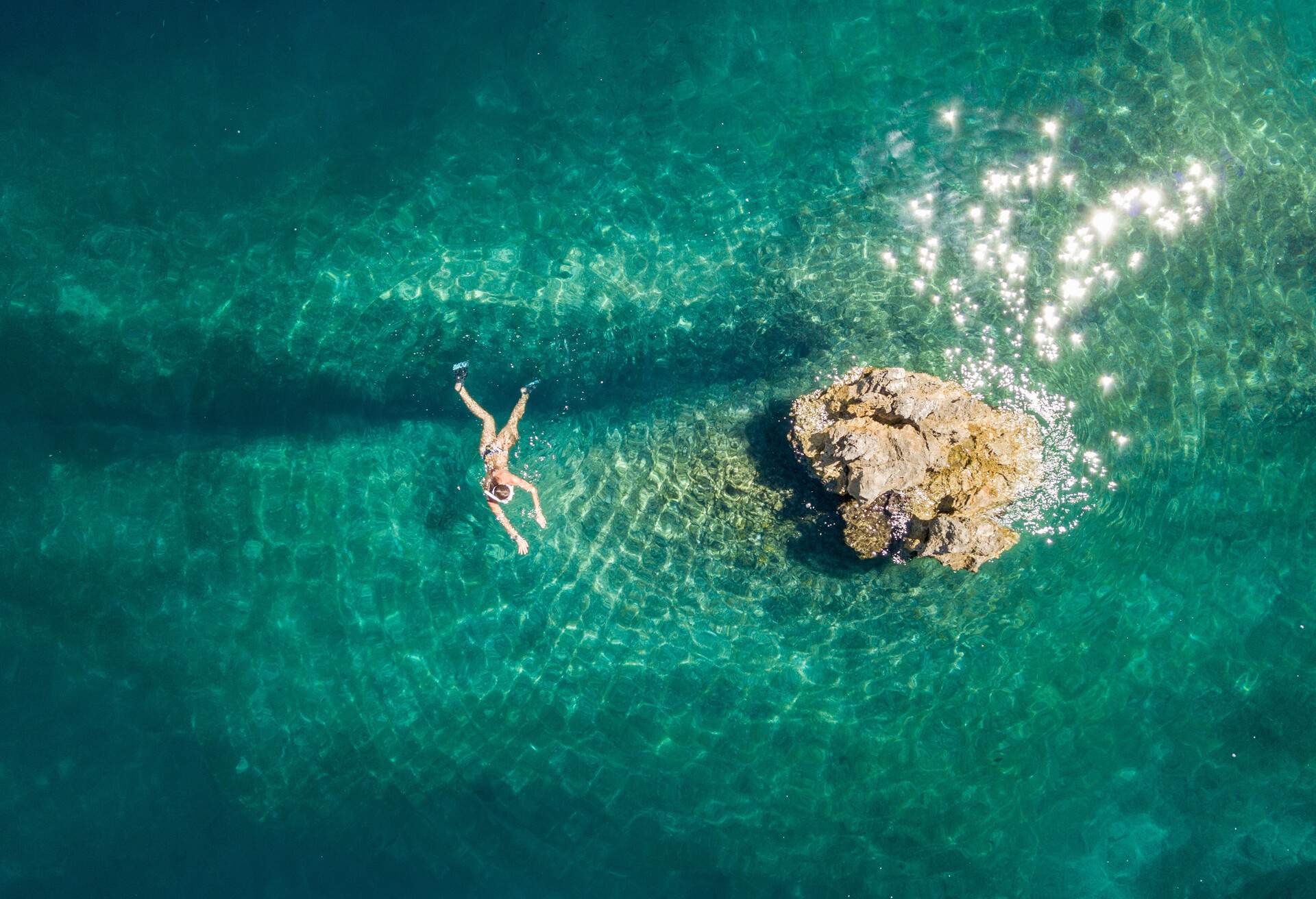 Woman snorkeling above amazing reef 