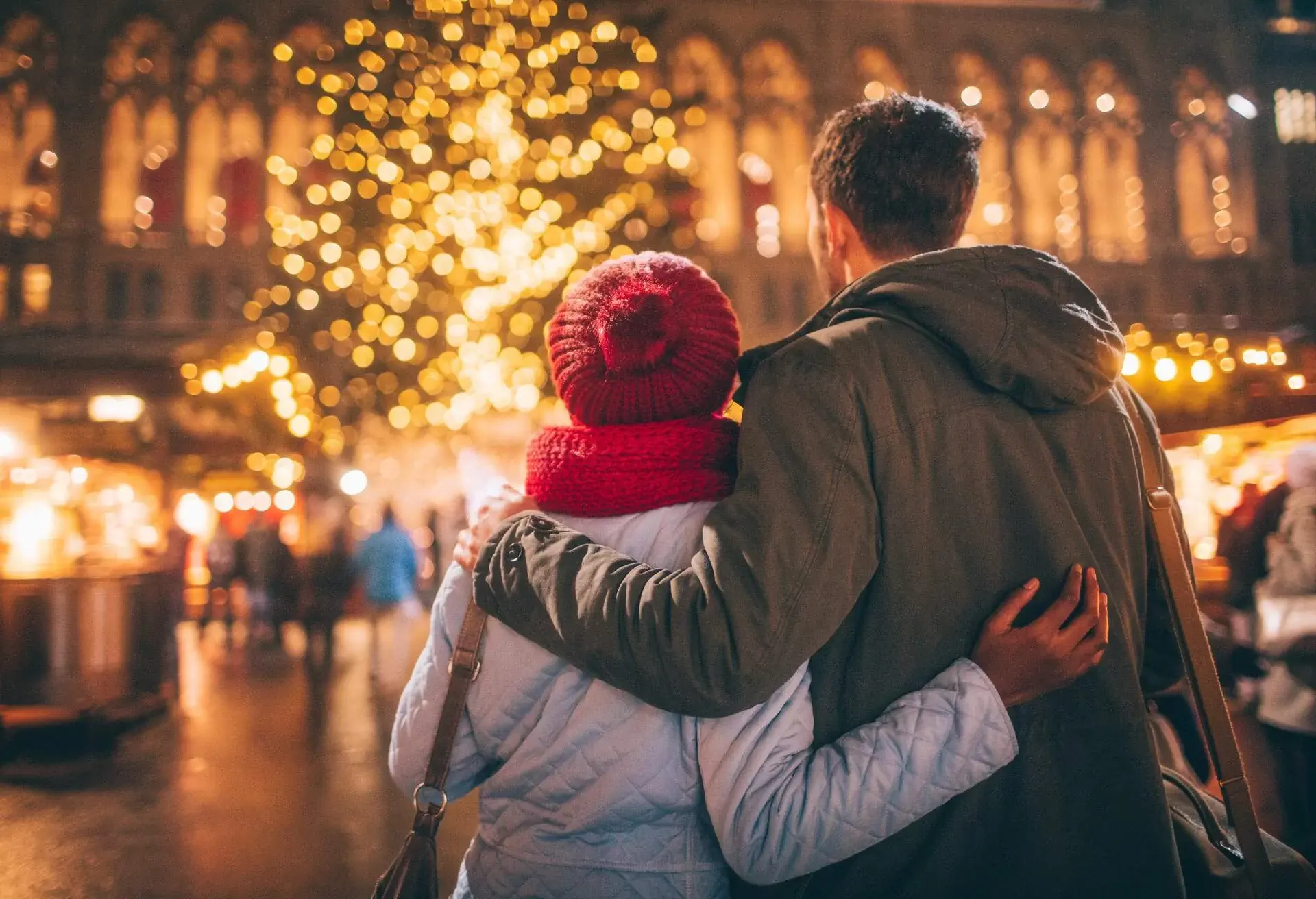 Photo of a young couple enjoy the decoration on Christmas Market, during Christmas Holidays