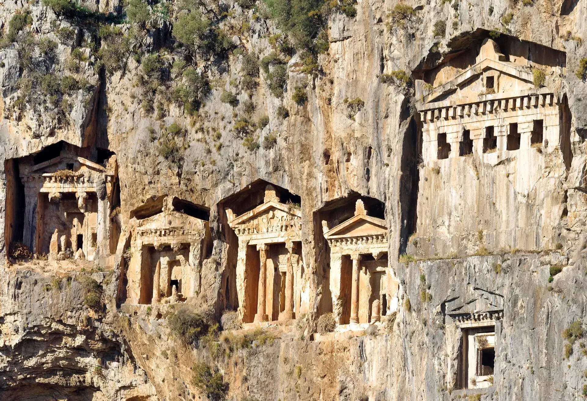 Turkey, Mugla Province, Fethiye, ancient tombs in rock, low angle view. .View of rock necropolis of Telmessos, Fethiye, Turkey, Lycian civilization, 4th century BC. The tombs were built by the Lycians about 300 BC.