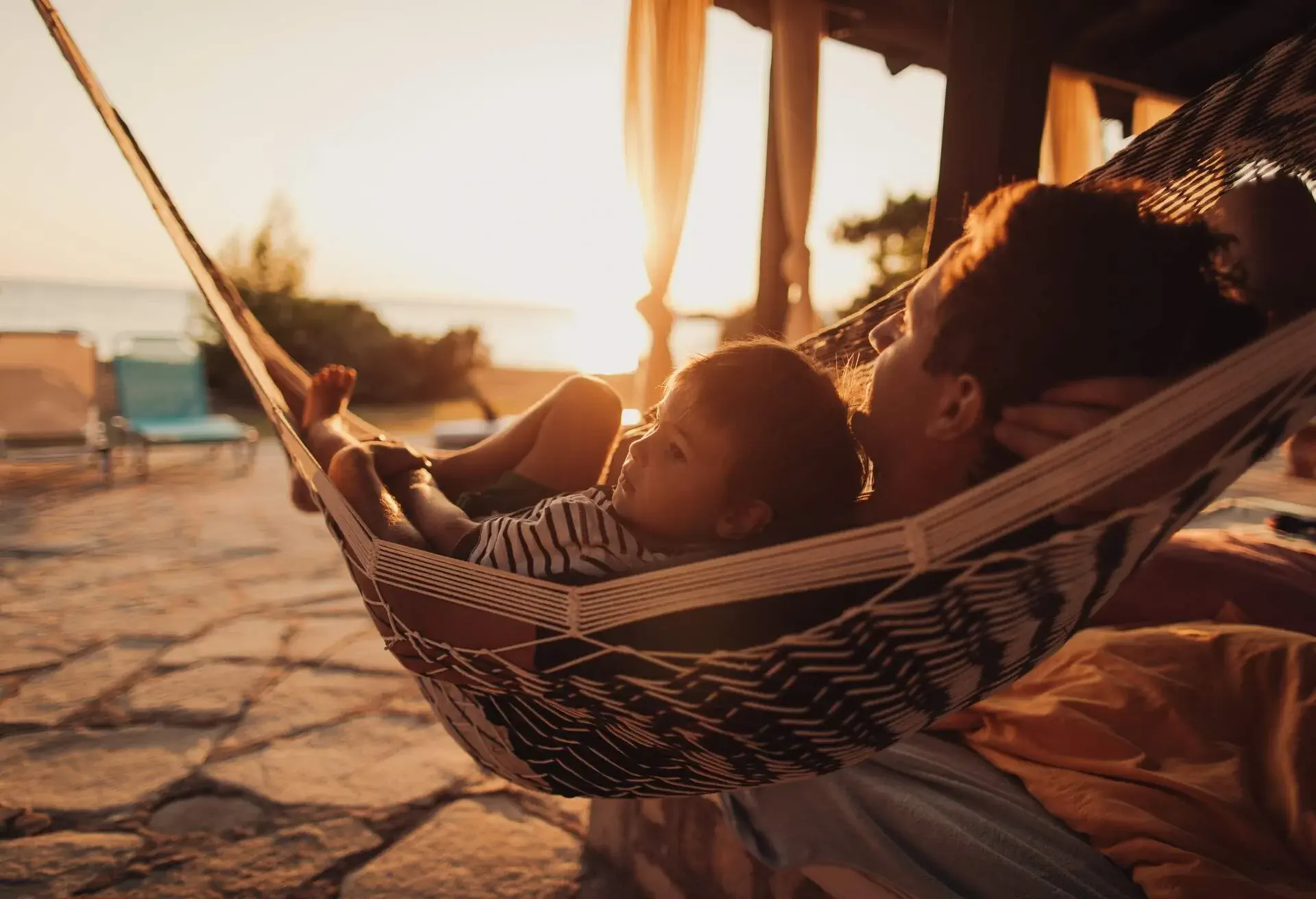THEME_PEOPLE_KID_CHILD_MAN_HAMMOCK_SUNSET_GettyImages