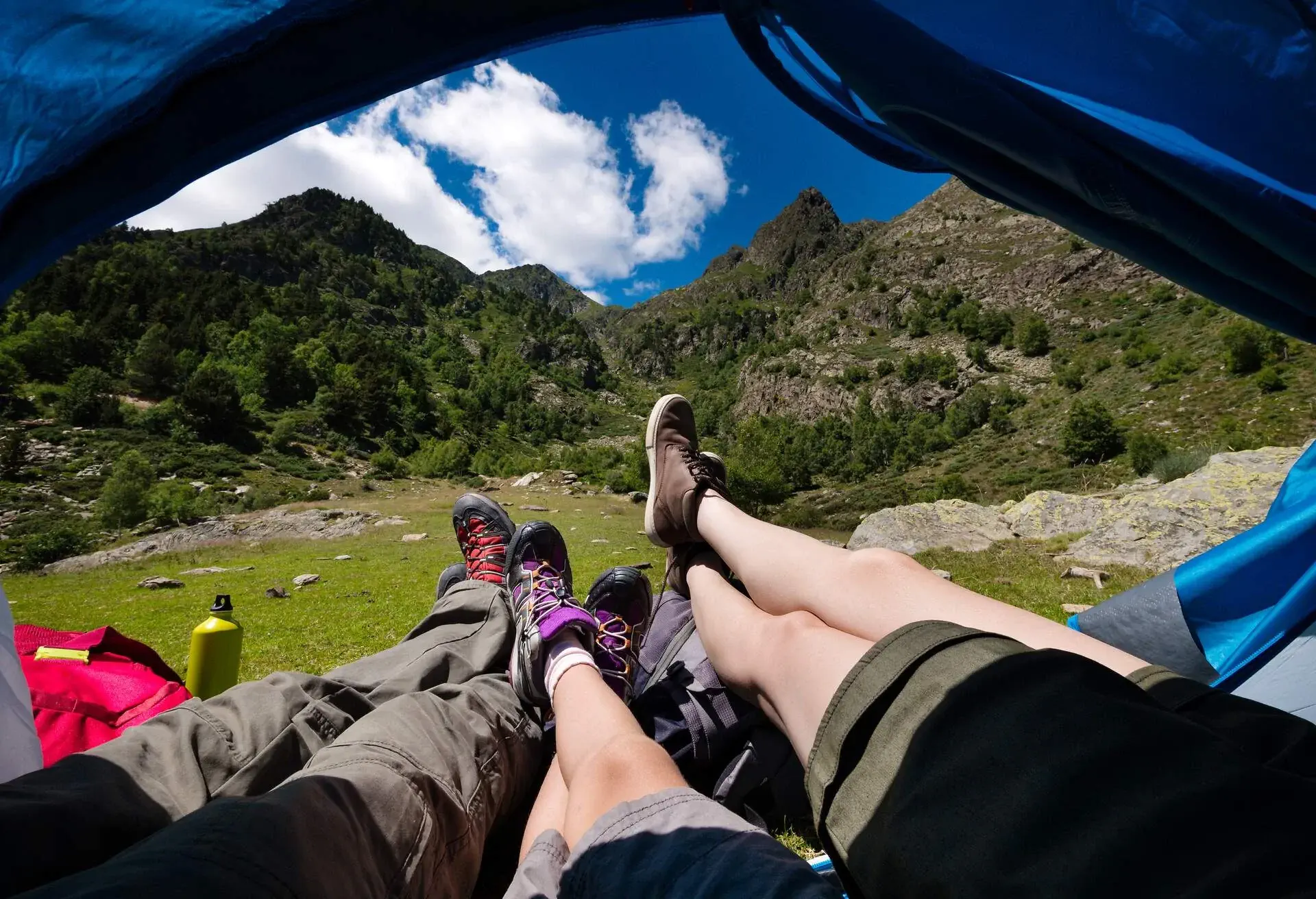 Family relaxing inside camping tent in the mountains