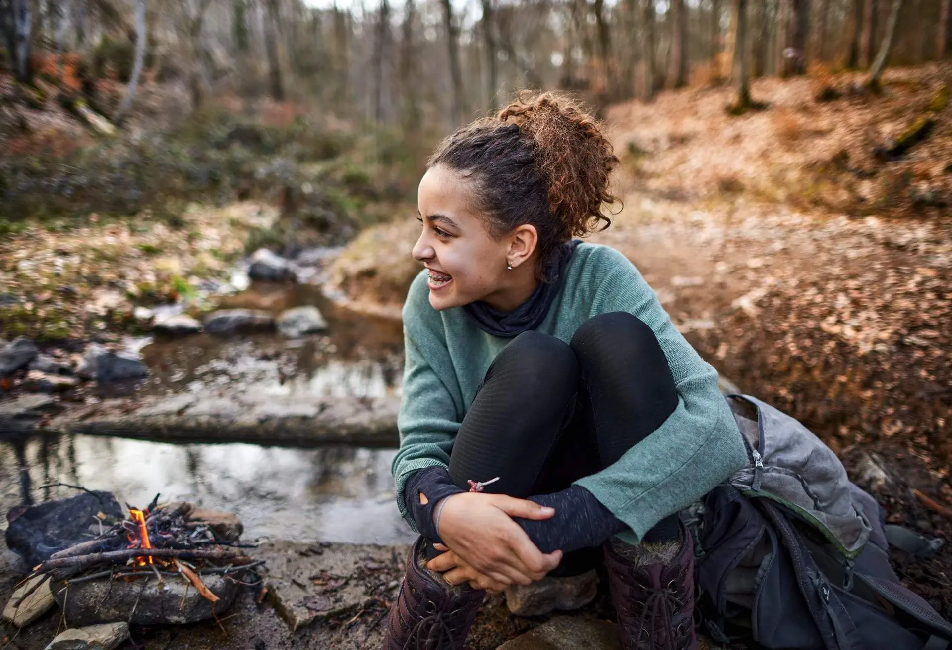 DEST_GERMANY_THEME_HIKING_CAMPING_CAMPFIRE_PEOPLE_WOMAN_GettyImages-1326255590