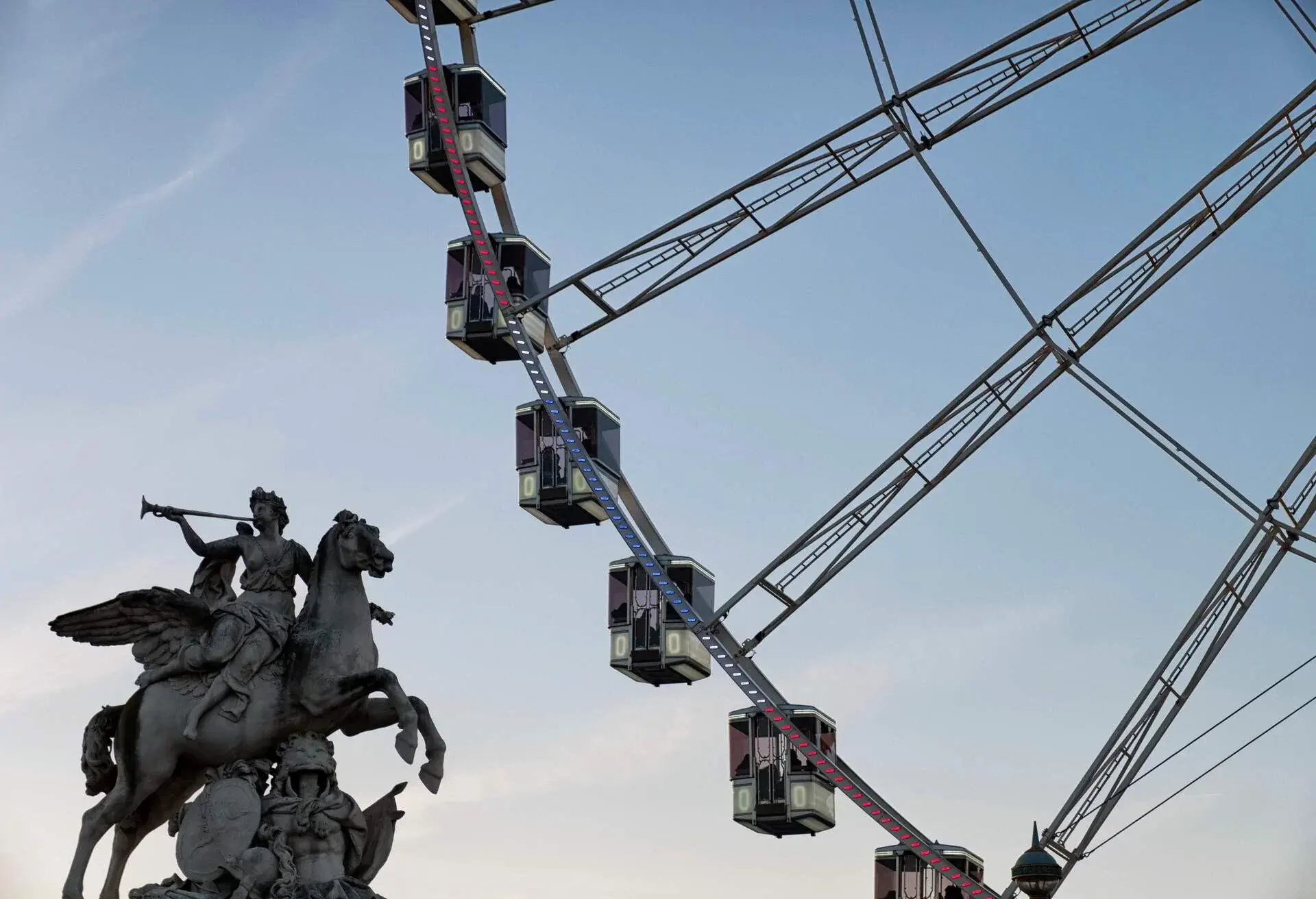 Close up of ferris wheel and silhouette of a statue nearby at Place de la Concorde at sunset during 2017 Chistmas holiday ,Paris.