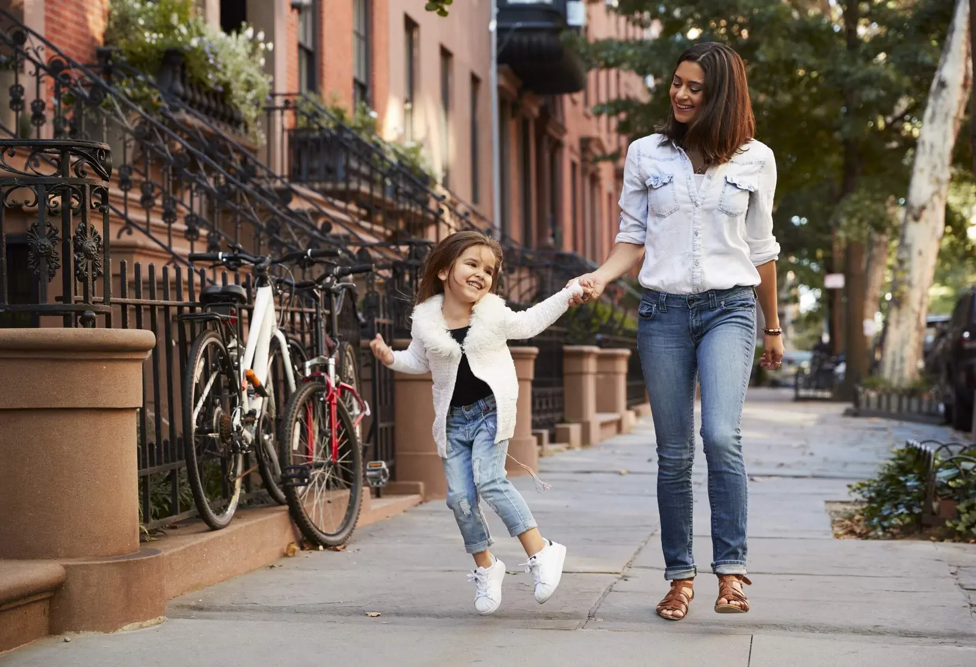 Mother and daughter walking down the street