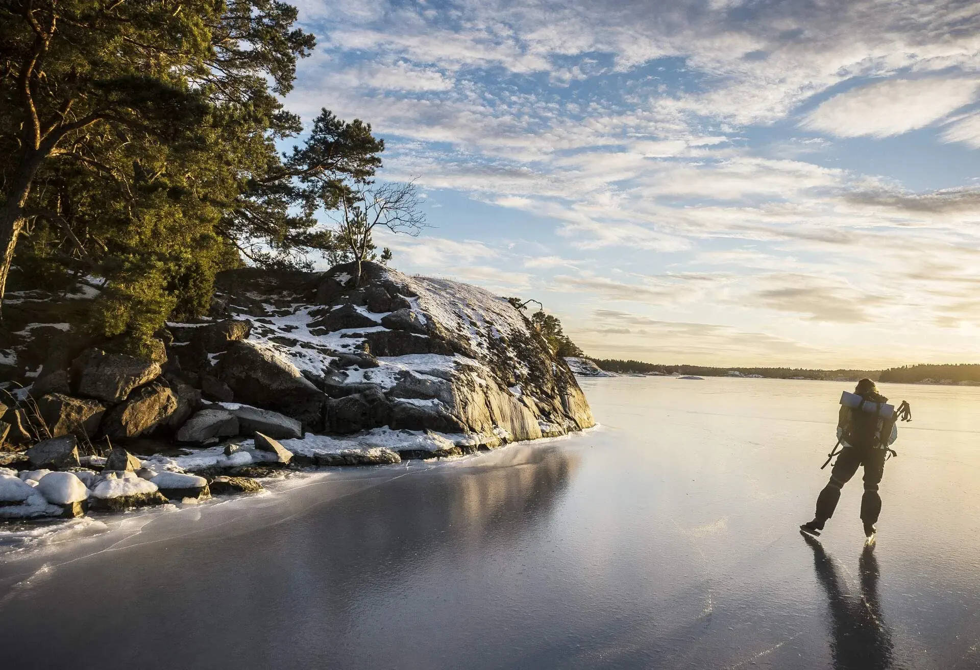 Man ice skating on the river in winter