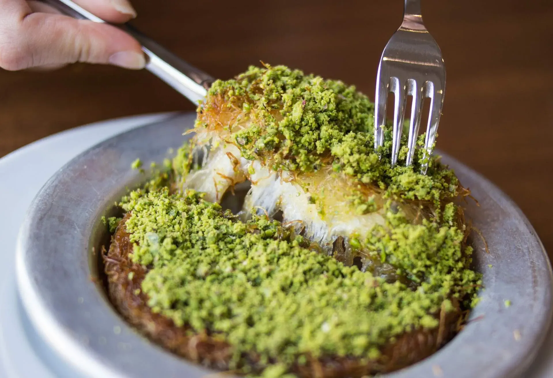 Kunefe / Turkish Traditional Dessert. Spelled kunafeh or kunafah is a cheese pastry soaked in sweet, sugar-based syrup, typical of the regions belonging to the former Ottoman Empire.