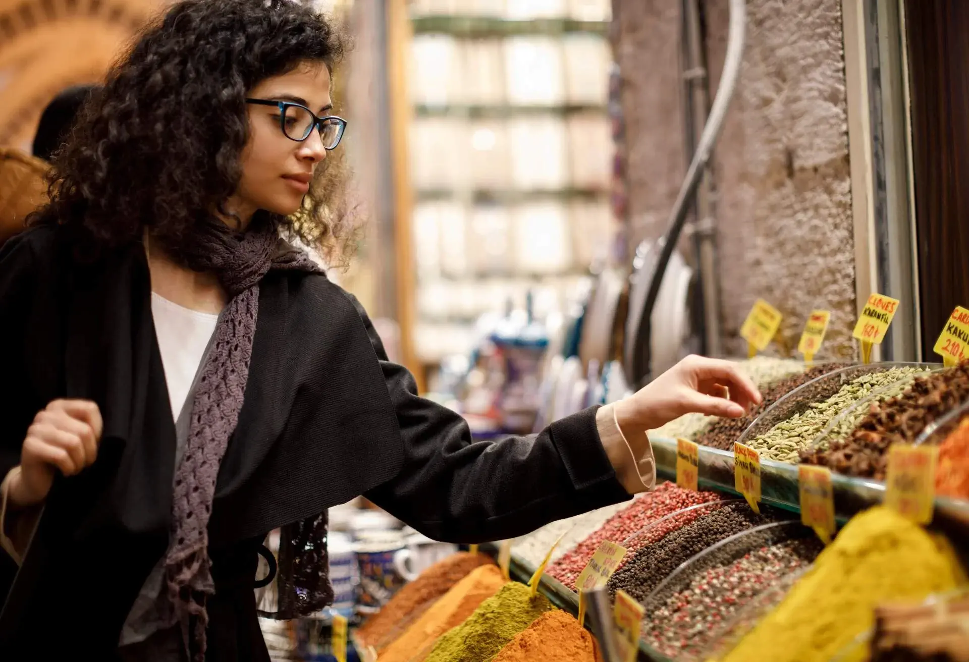 Woman shopping in spice shop in Grand Bazaar, Istanbul, Turkey