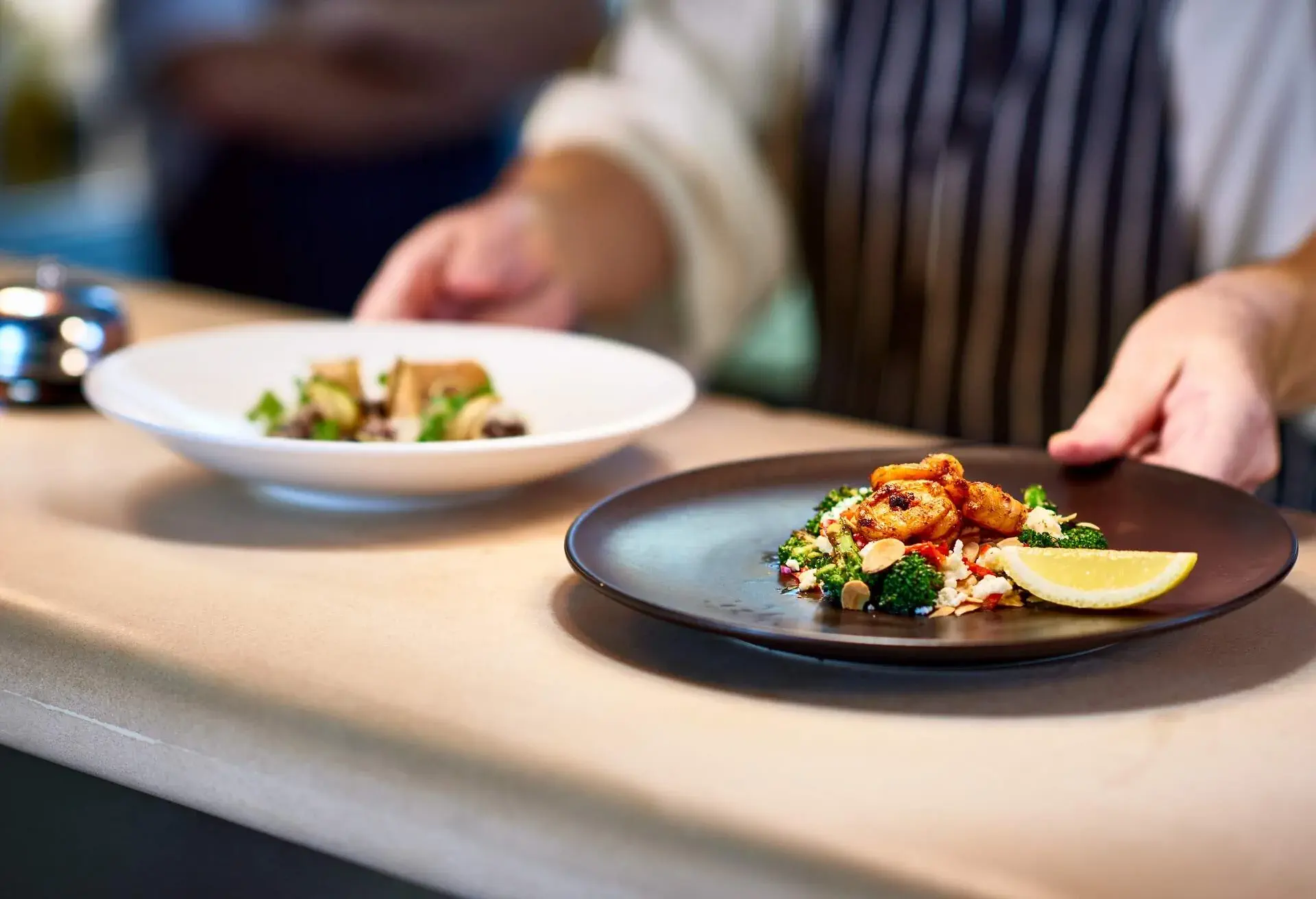 Professional chef working in commercial kitchen, preparing food, serving meal, service